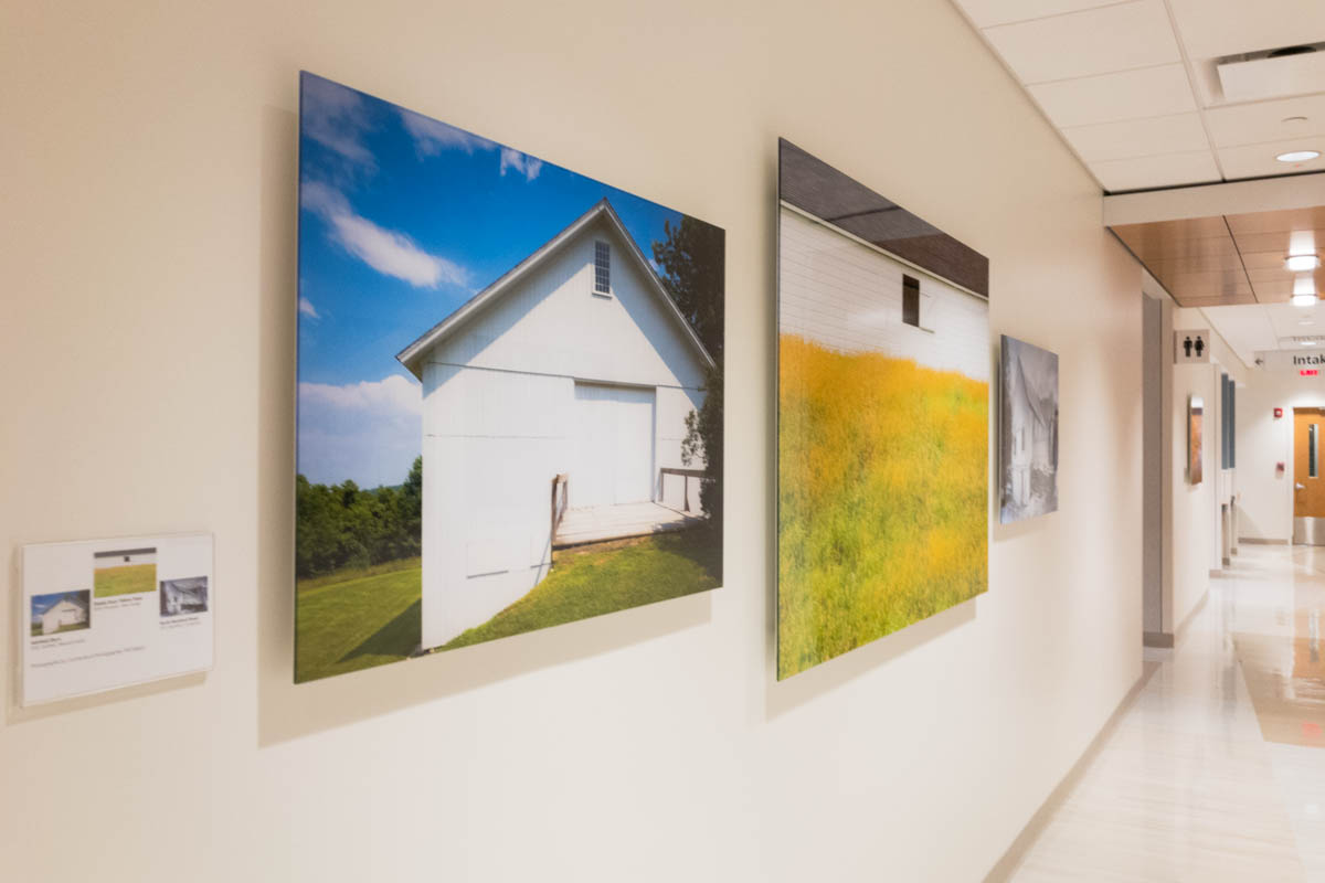 long hallway with three acrylic face mounted prints in the foreground