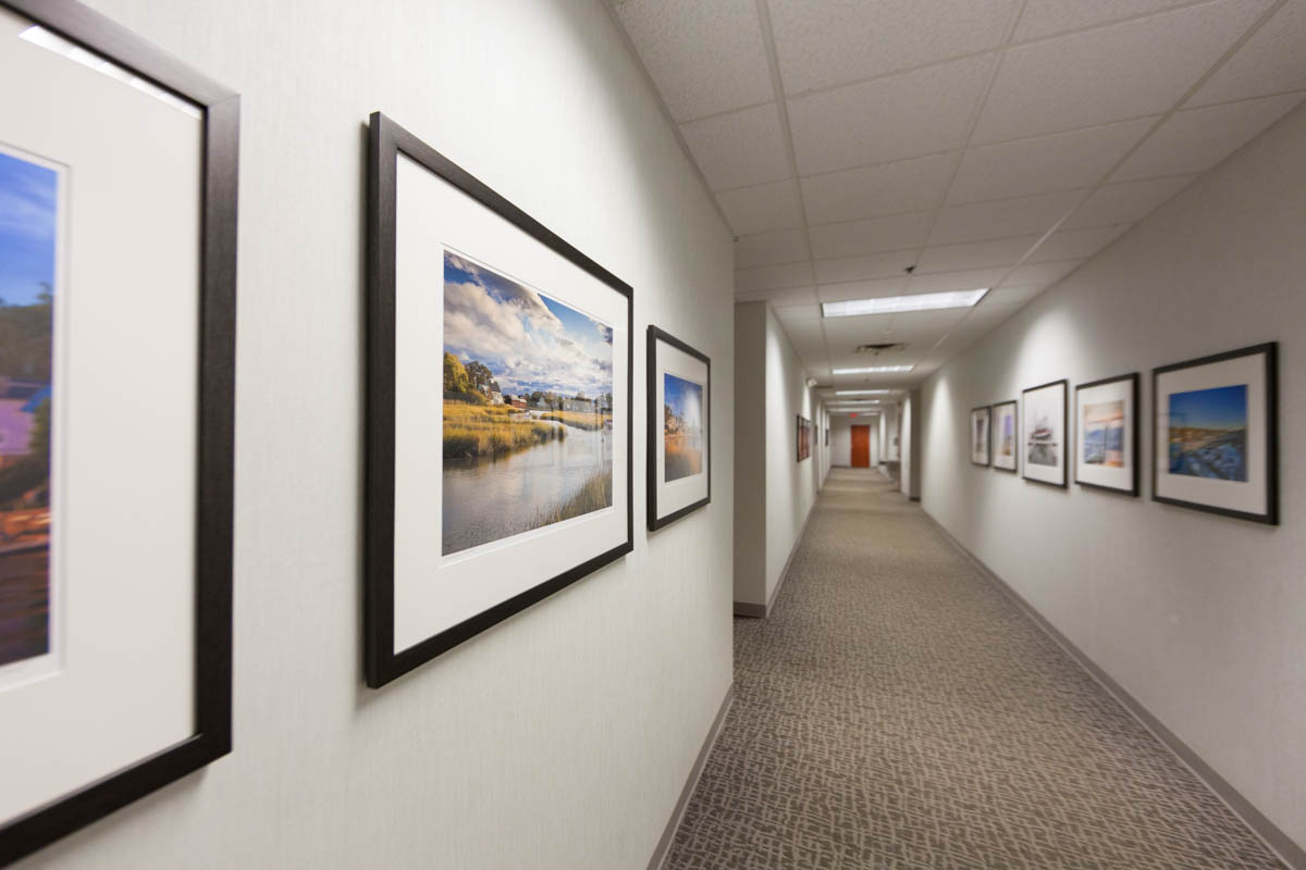 long hallway with three acrylic face mounted prints in the foreground