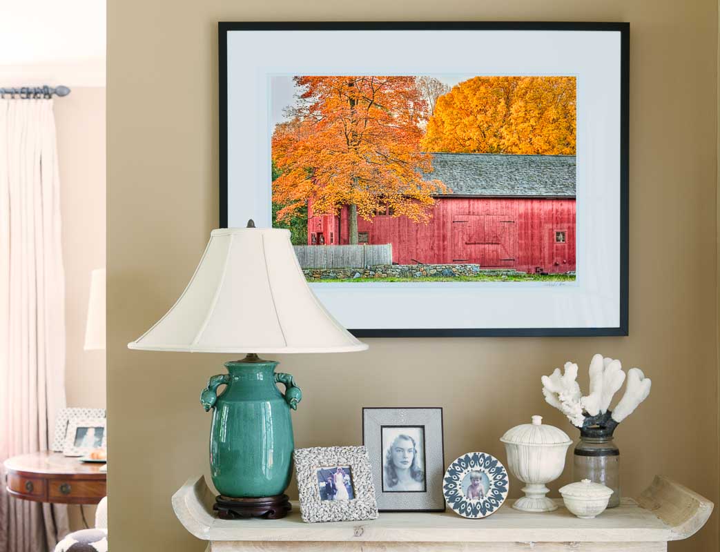 framed picture of barn on living room wall